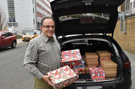 Uwe Ochs loading the gift boxes packed by colleagues in Frankfurt for delivery to the charity Geschenke der Hoffnung.