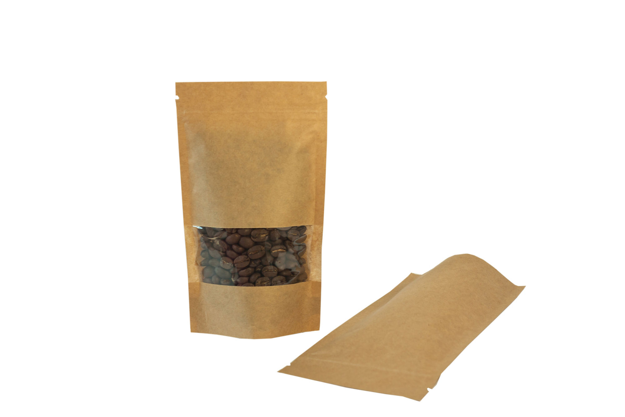Brown kraft paper pouch bags with coffee beans front view on a wooden background. Packaging for foods and goods template mock-up. Packs with clasps and windows for tea leaves and weight products.