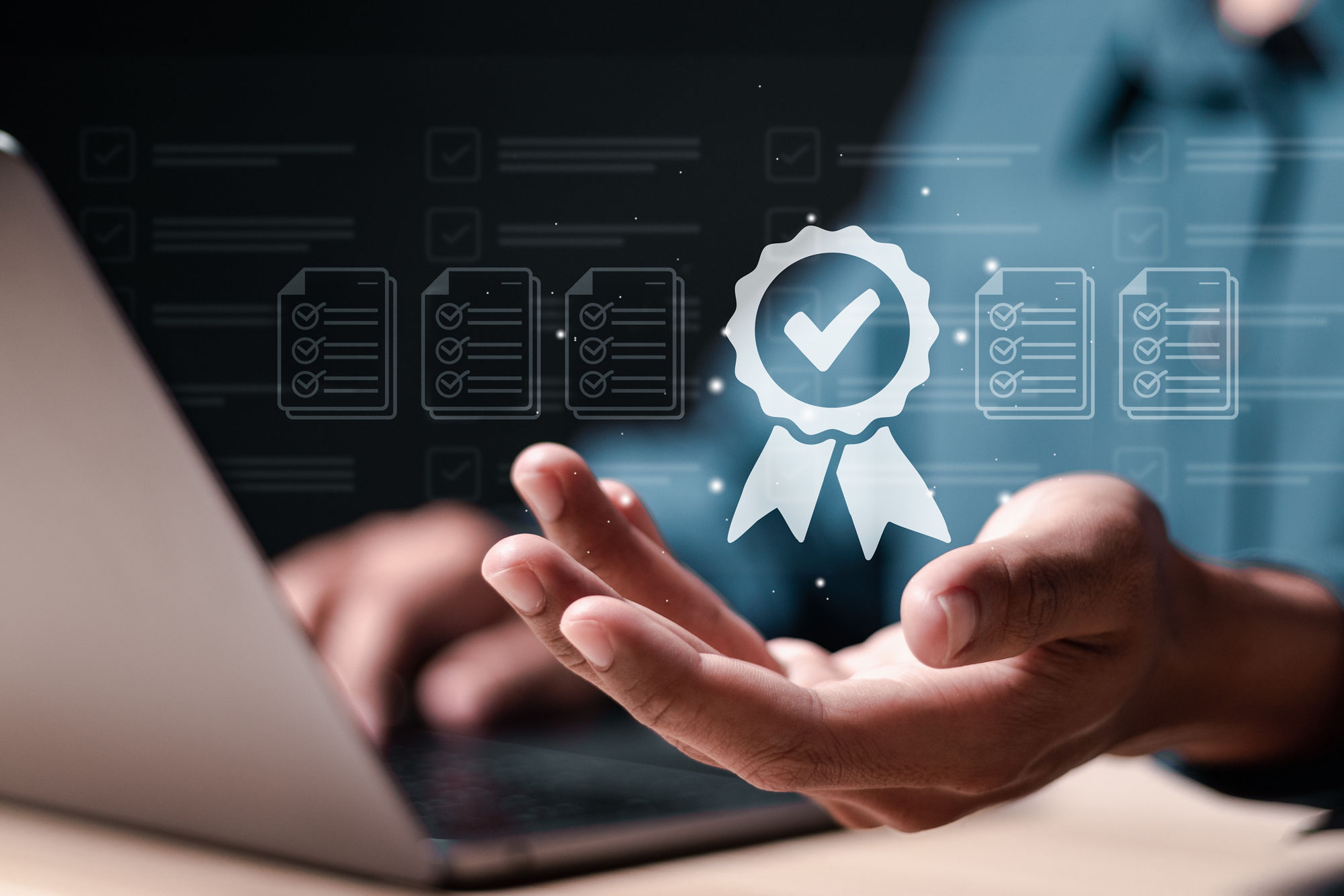 Quality assurance concept. Person use laptop with virtual high quality assurance mark for ISO certification and standardization. certificate, approval, compliance to requirements.
