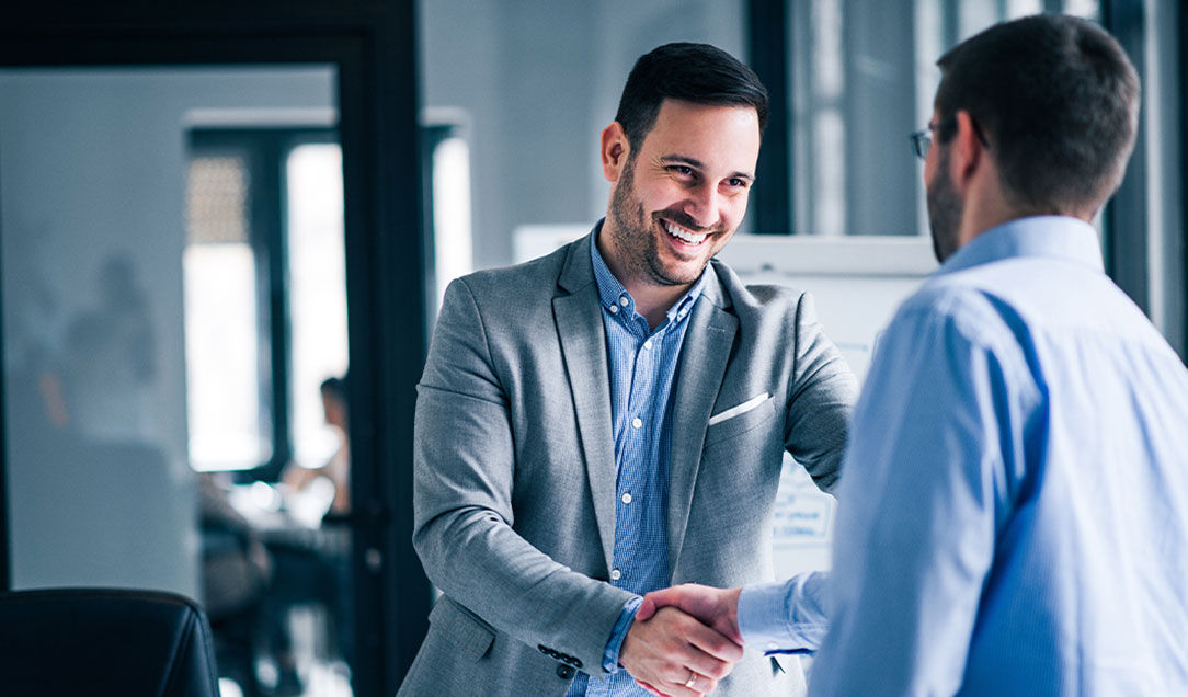 Two people are greeting each other for a job interview at Kuraray.